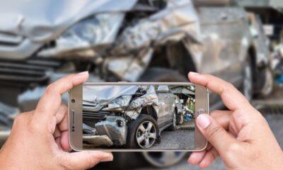 person taking photo of car crash