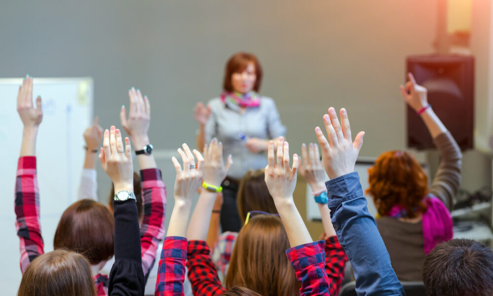 Active Students raising Arms up ready to answer Teachers Question