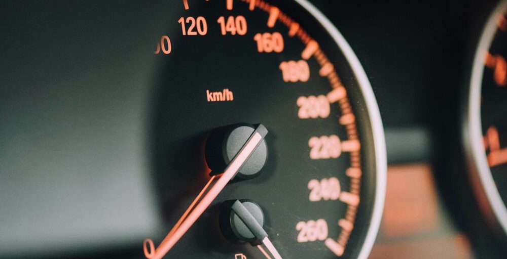 closeup photo of black analog speedometer