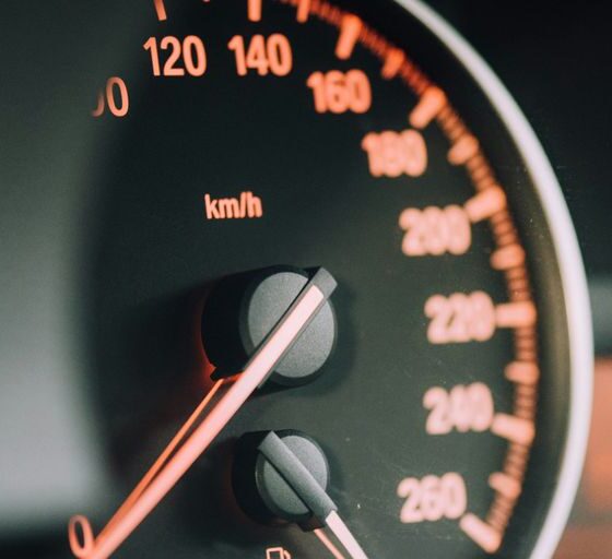 closeup photo of black analog speedometer