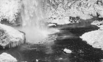 a black and white photo of a waterfall