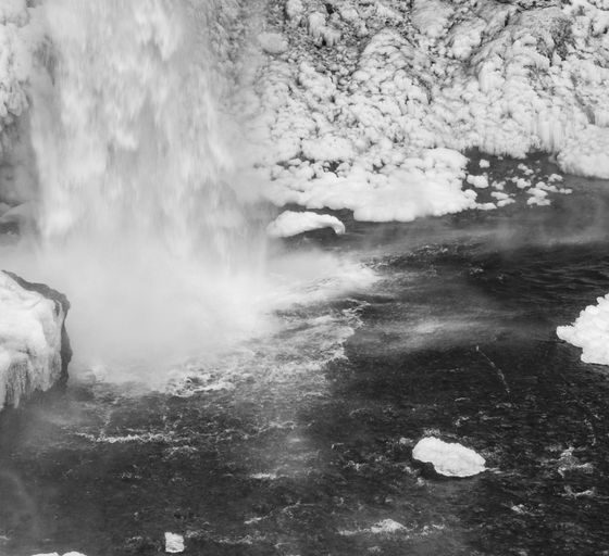 a black and white photo of a waterfall