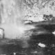 a black and white photo of a waterfall