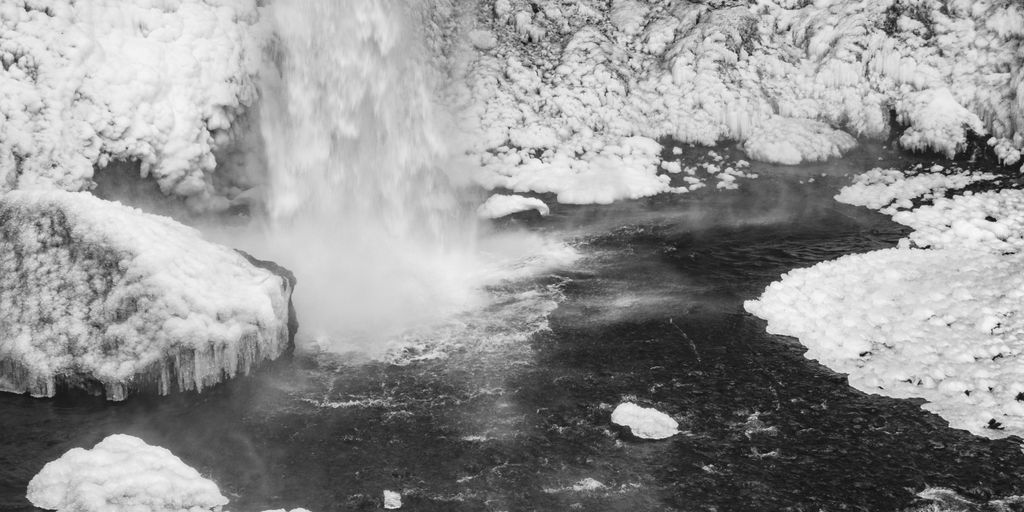 a black and white photo of a waterfall