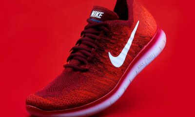 unpaired red Nike sneaker