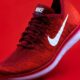 unpaired red Nike sneaker