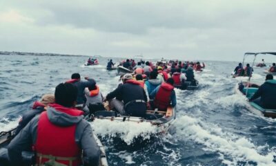 Crowded small boat channel with multiple vessels in motion.