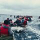 Crowded small boat channel with multiple vessels in motion.