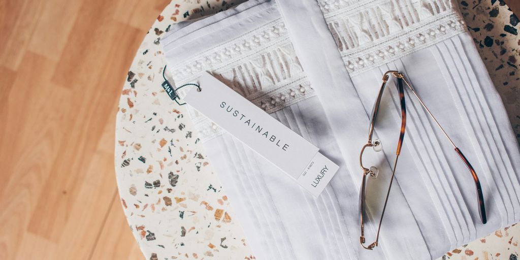 silver framed eyeglasses on white and blue floral textile