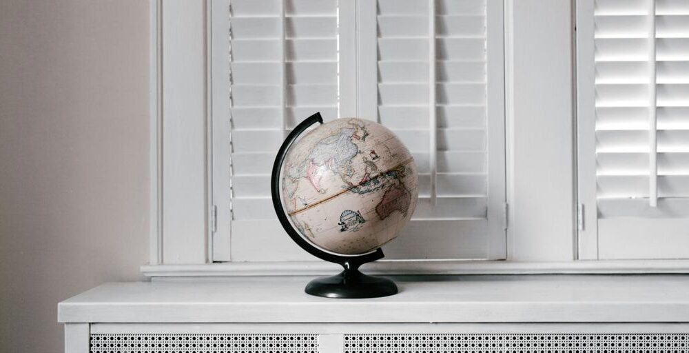 beige desk globe on white desk