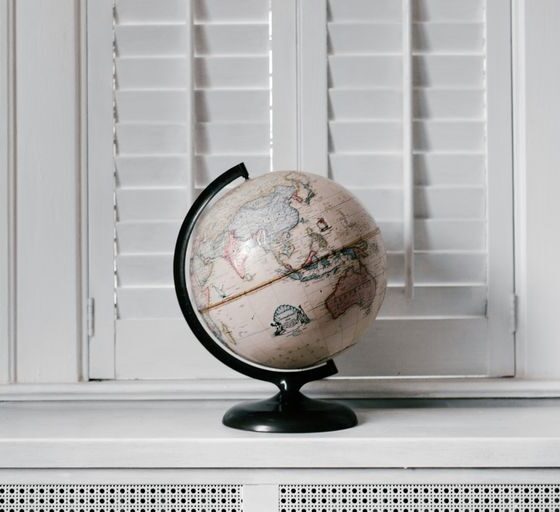 beige desk globe on white desk