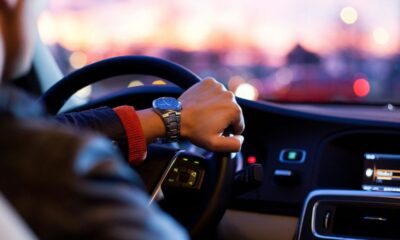 man driving a car wearing wrist watch