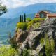 a house on top of a mountain overlooking a valley