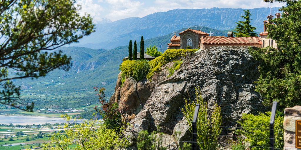 a house on top of a mountain overlooking a valley