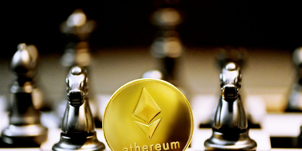 a gold ethereum coin sitting on top of a chess board