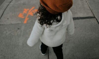 girl walking on side walk in street