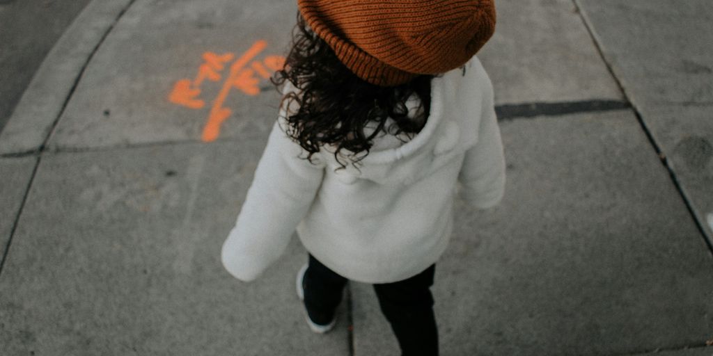 girl walking on side walk in street