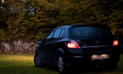 a small black car parked in a grassy area