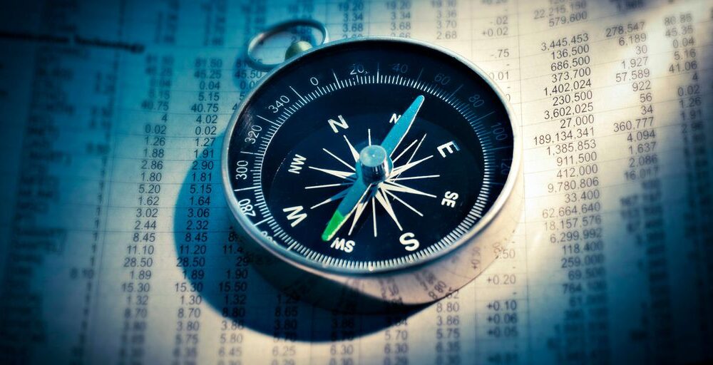 shallow focus photograph of black and gray compass