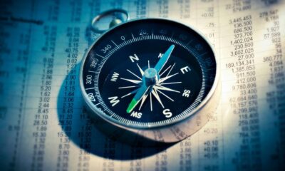 shallow focus photograph of black and gray compass