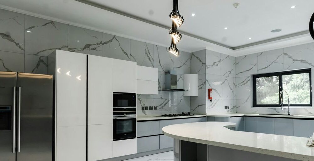 a modern kitchen with marble counter tops and stainless steel appliances