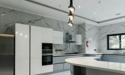 a modern kitchen with marble counter tops and stainless steel appliances