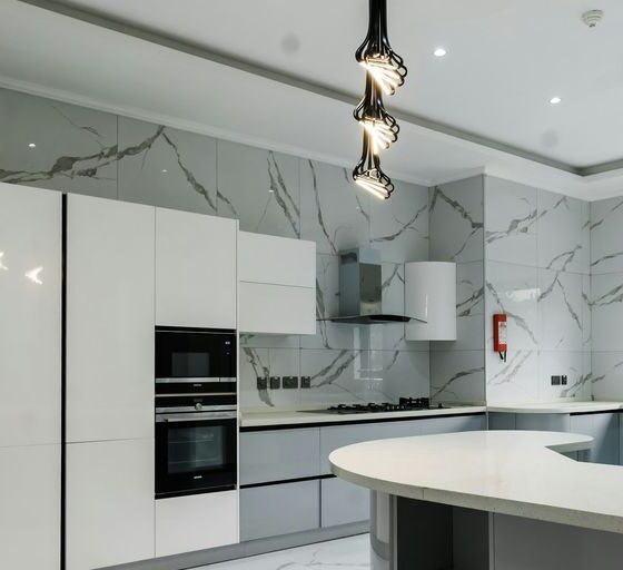 a modern kitchen with marble counter tops and stainless steel appliances