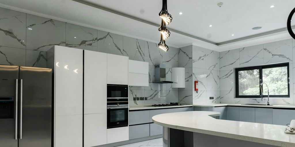 a modern kitchen with marble counter tops and stainless steel appliances