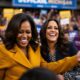 Michelle Obama and Kamala Harris smiling at rally.