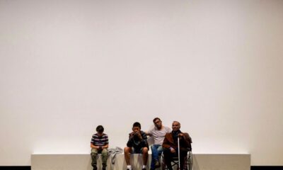 group of people sitting on blue bench