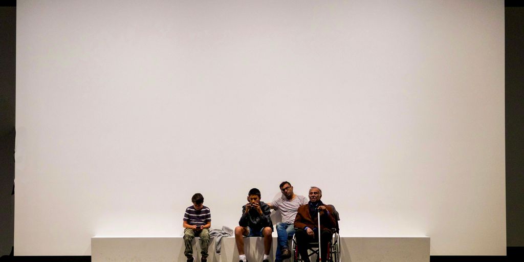 group of people sitting on blue bench