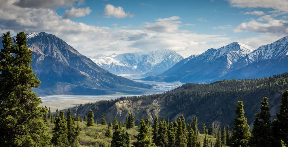 green mountain across body of water