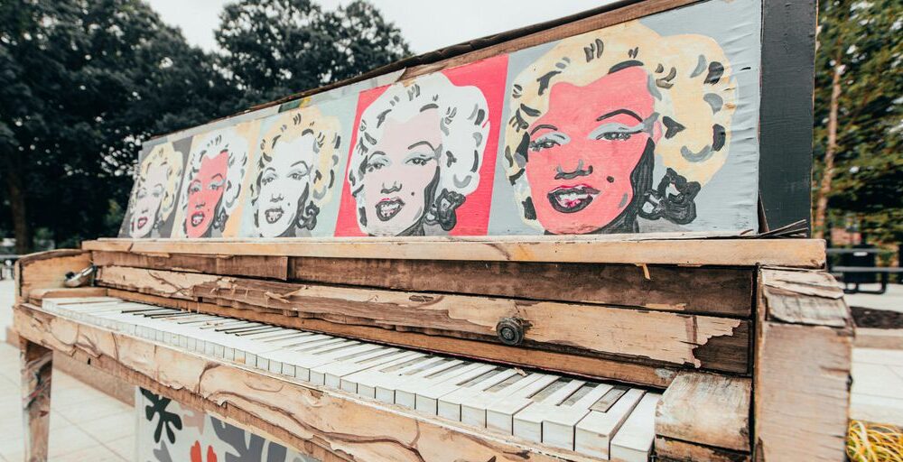 white and red graffiti on brown wooden fence