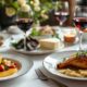 Elegant table set with French cuisine and wine.