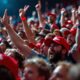 Crowd of supporters at a rally, showing excitement.