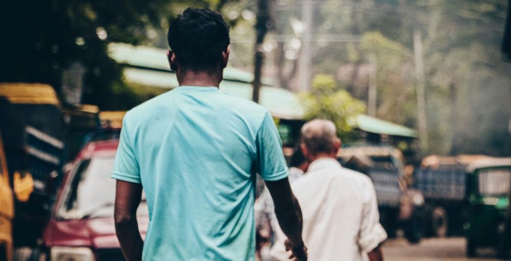 a couple of men walking down a street