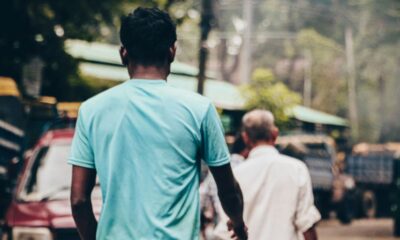 a couple of men walking down a street