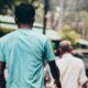 a couple of men walking down a street