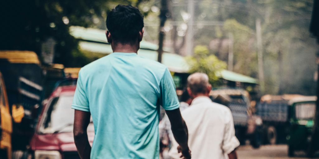 a couple of men walking down a street