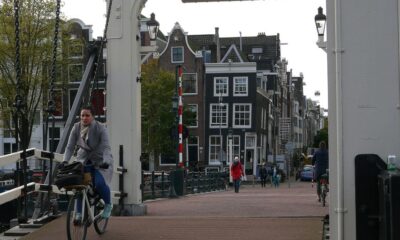 a man riding a bike across a bridge