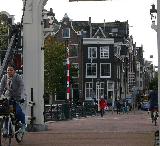 a man riding a bike across a bridge