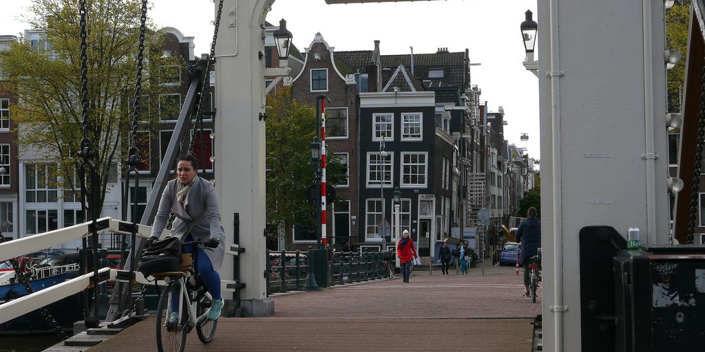 a man riding a bike across a bridge