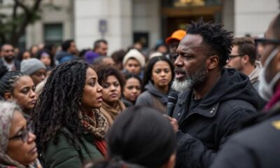 Diverse group discussing immigration outside a government building.