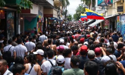 Crowded Miami street with Venezuelan flags and diverse people.