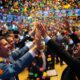 Traders celebrating on a busy stock exchange floor.