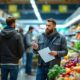 Grocery store aisle with empty shelves and concerned shoppers.