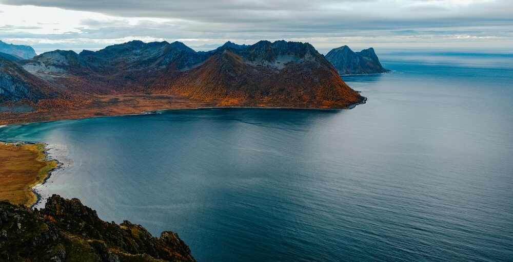 a body of water with mountains in the background