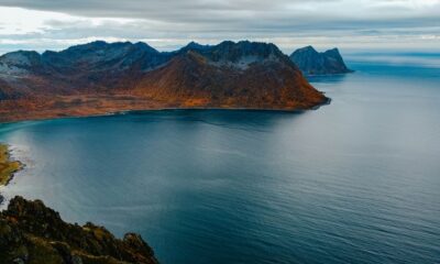 a body of water with mountains in the background