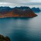 a body of water with mountains in the background