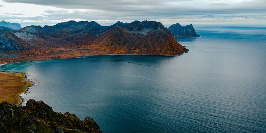 a body of water with mountains in the background